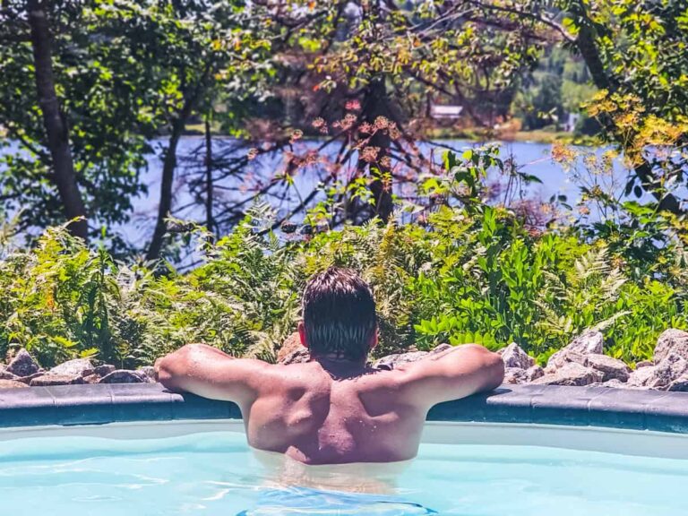 man in thermal pool looking at lake at sensea spa